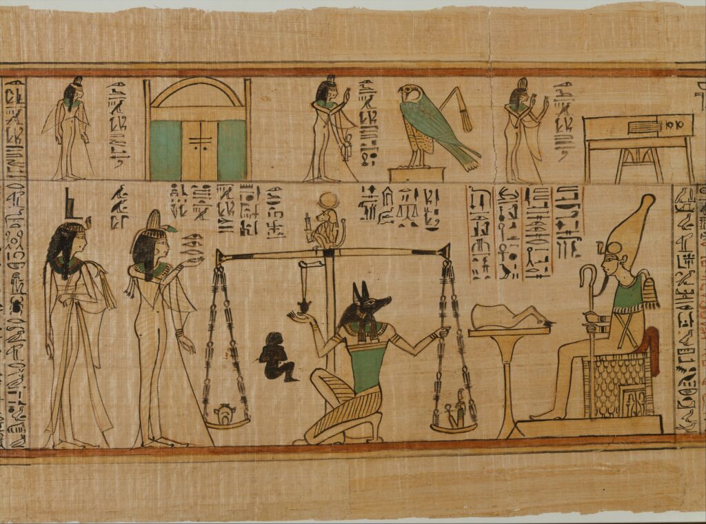 anubis-ksiega-umarlych-nauny-the-met.jpg Fragment egipskiego papirusu z Księgi Umarłych Nauny, z przedstawieniem Anubisa ważącego serce zmarłej przed Ozyrysem.